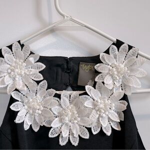 Taylor Black dress W/ white floral detail.